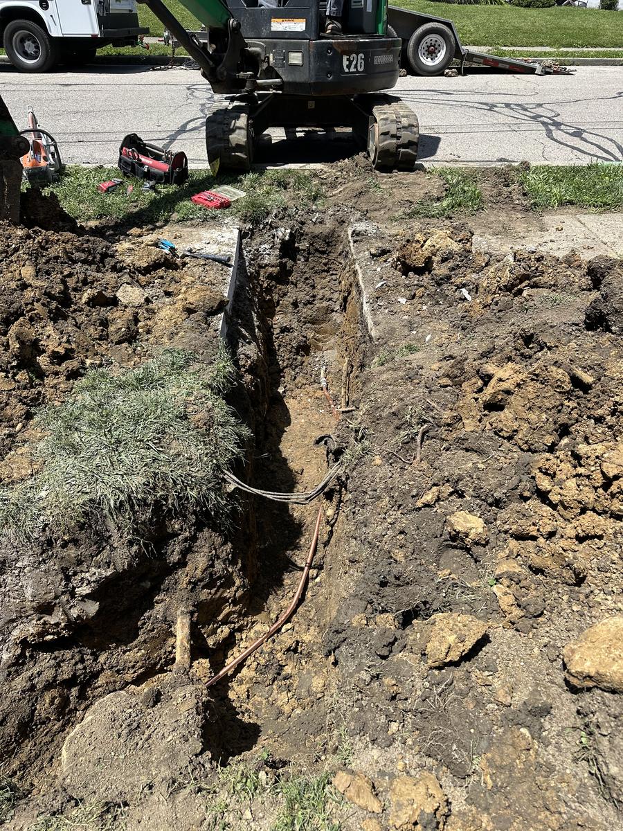 Water line replacement in progress — trench open and new line going in